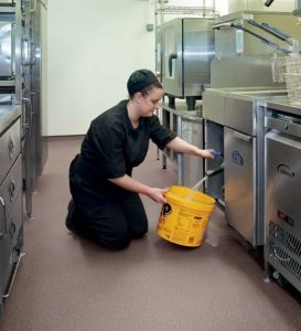 woman getting water in the kitchen