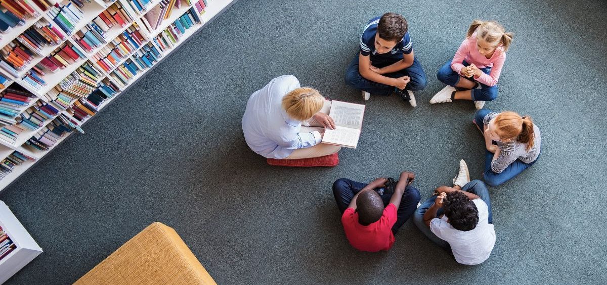 children reading on the library floor